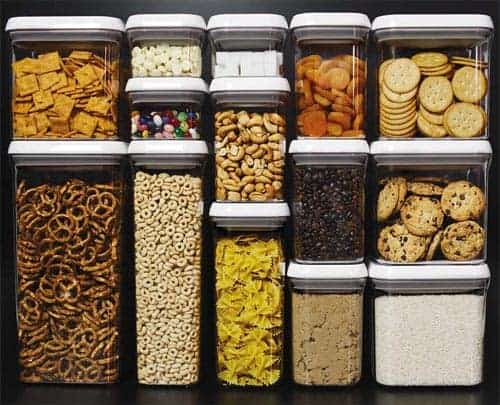 A group of SMART food storage containers filled with cookies and crackers.