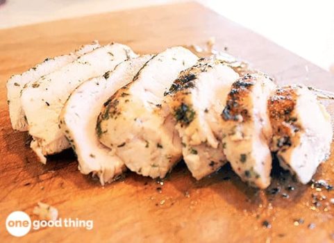 Perfectly cooked chicken breast on a cutting board.