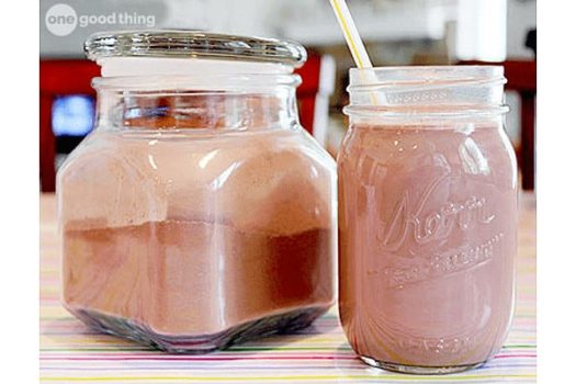 A jar of homemade Nesquik with a straw next to it.