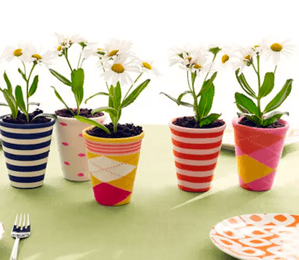 A simple table adorned with a tablecloth and flowers in a vase