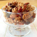 Highly addicting granola clusters in a glass bowl on a table.