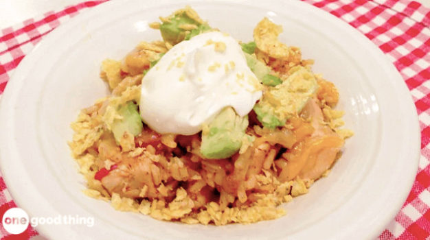 A Southwest-inspired one-pot dish featuring chicken and rice topped with creamy sour cream and avocado.