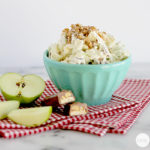 A blue bowl with a Snickers Salad in it.