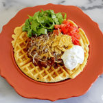 A plate with a waffle on it.