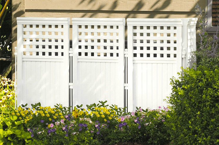 A genius backyard privacy screen in front of a house, providing the perfect hang out spot.
