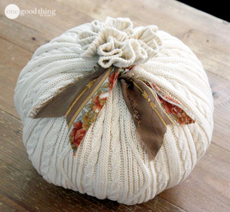 A pumpkin made from the body of an old orange sweater, tied with a ribbon