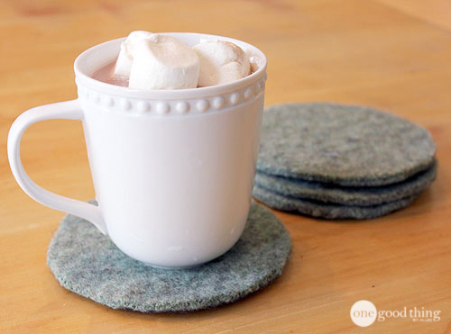 Coasters cut from a felted wool sweater under a mug of hot chocolate
