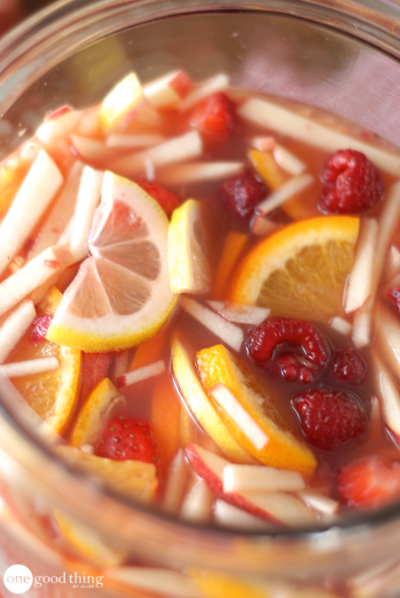 Virgin Sangria to make in February large pitcher holding Virgin Sangria mocktail