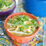 Two hearty bowls of white bean chicken chili on a table.