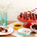 A table with a bunch of Meatballs on it, cooked in a Crockpot using a 3-Ingredient recipe.
