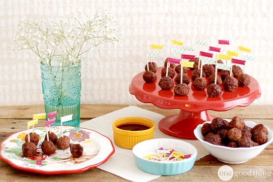 A table with a bunch of Meatballs on it, cooked in a Crockpot using a 3-Ingredient recipe.