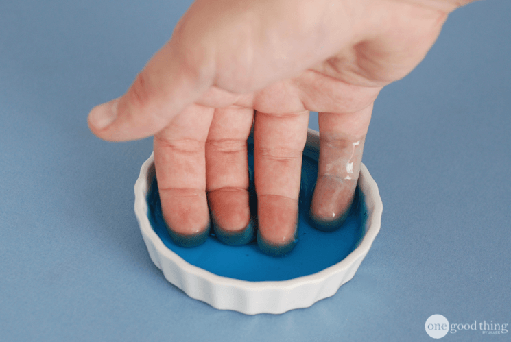 Softening Cuticles For Manicures with blue dawn dish soap fingers dipped into a saucer with blue dawn dish soap