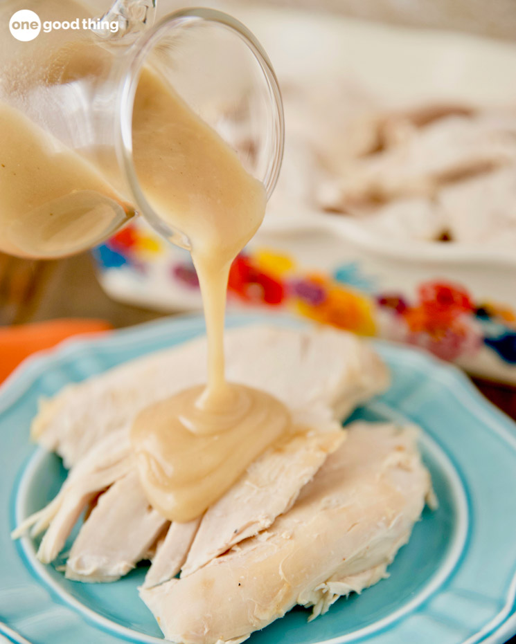 Gravy being poured onto white meat turkey