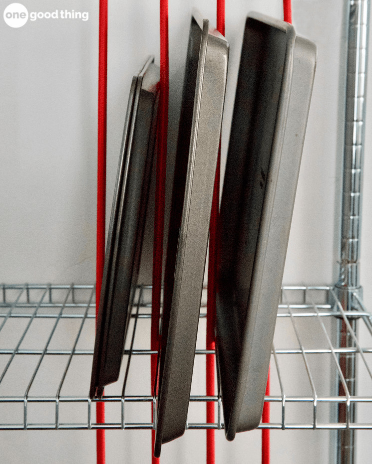 Stretch bungee cords vertically between shelves to keep sheet pans upright while being stored. 