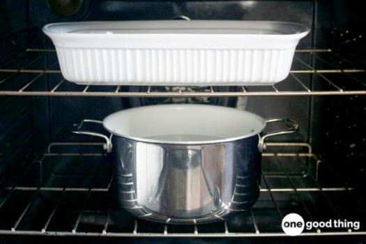 Clean your oven with the help of a pot and a pan.