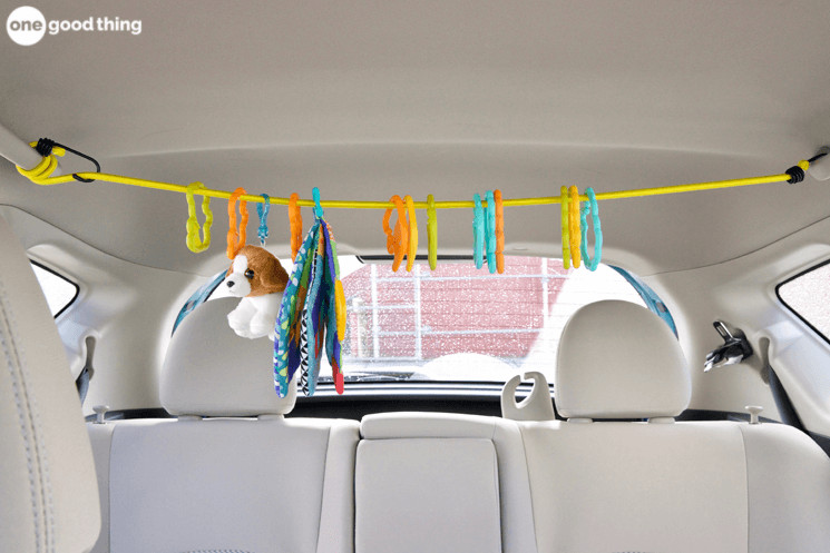 Use a bungee cord stretched over the back seat of your car to suspend baby's favorite toys -- like a toy mobile!