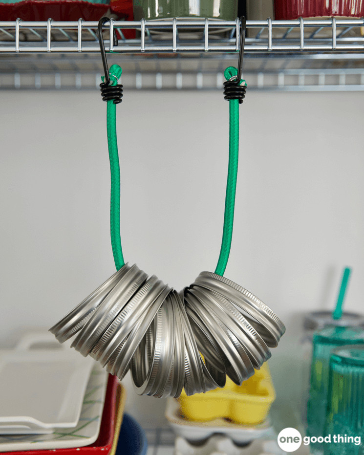 Use a bungee cord to suspend your canning jar lids under a shelf.