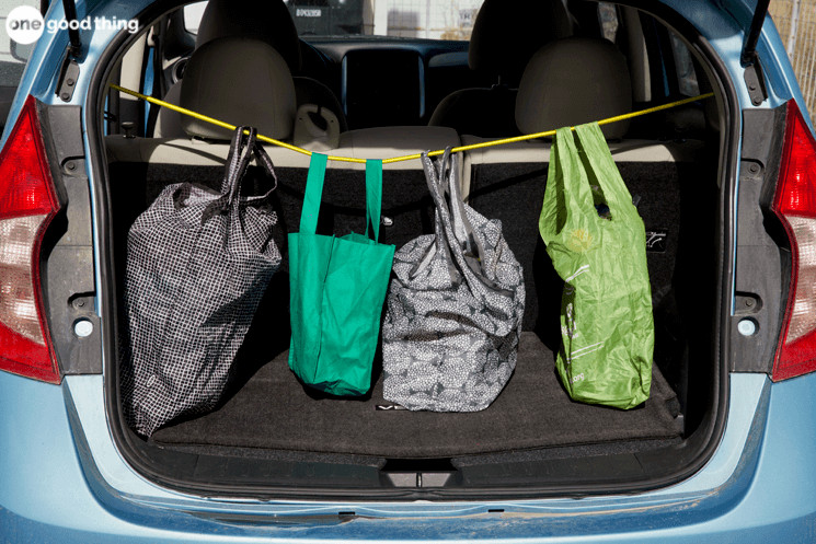 Use a bungee cord to keep your groceries from rolling all around - simply string it between the two sides of your trunk and thread it through the bag handles.