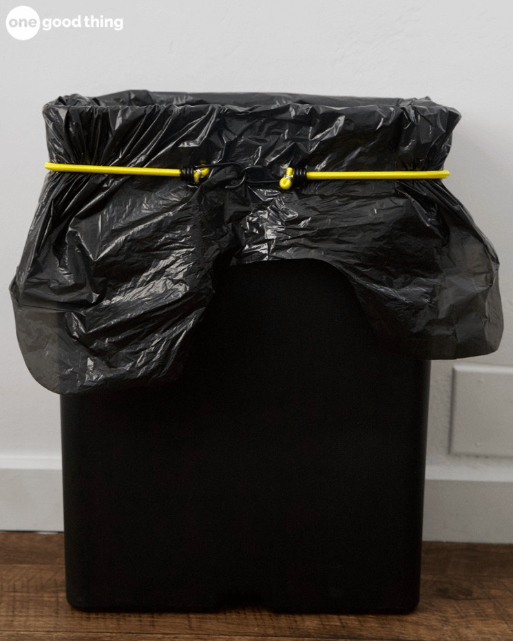 Use a bungee cord around the can to keep trash bags from sliding down.