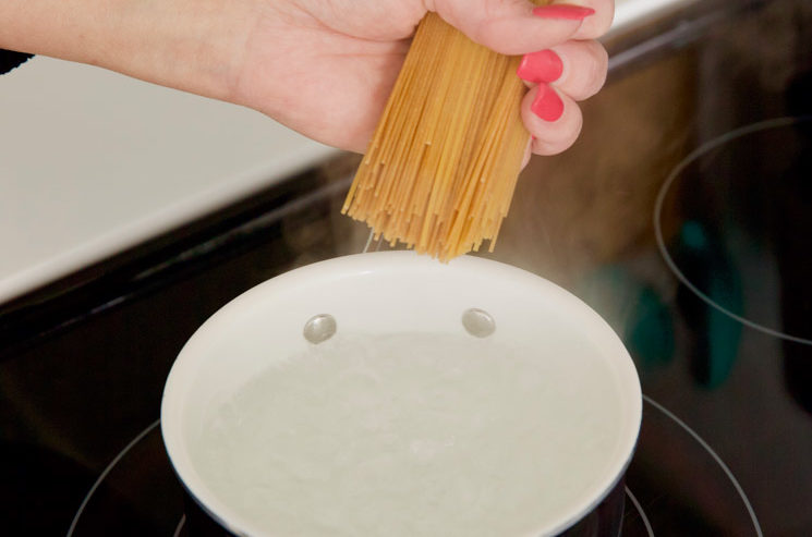 cooking spaghetti in a small pot