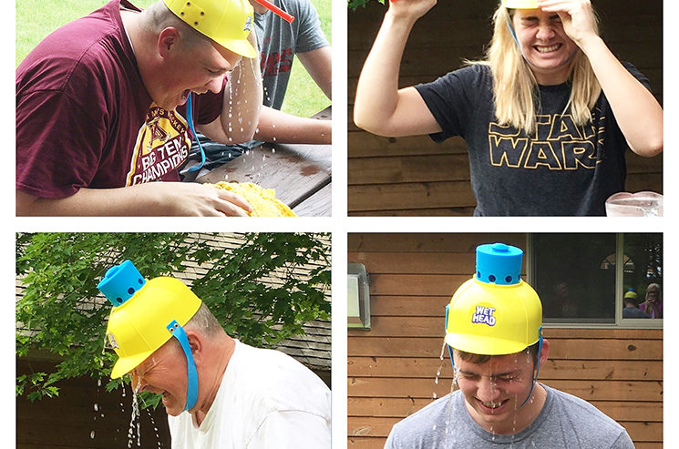A man is wearing a yellow hat at a party.