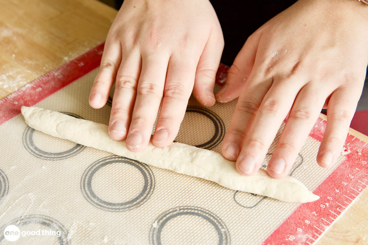 rolling out 2 ingredient dough into a breadstick shape