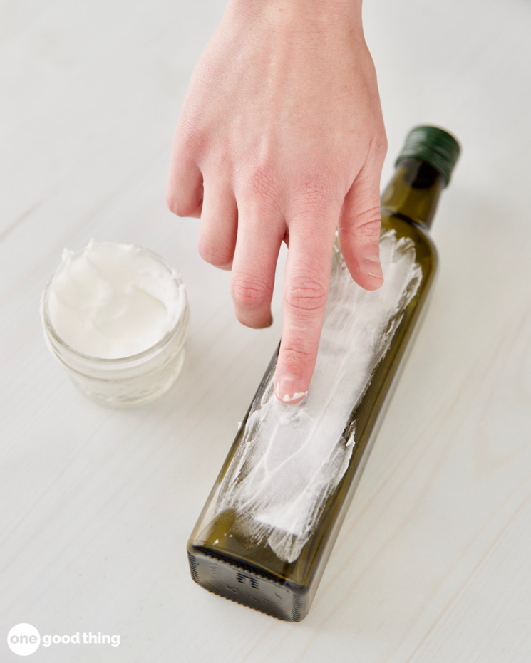 DIY Goo Gone Gunk Remover DIY Goo Gone Gunk Remover - spreading the diy goo gone on label residue on bottle