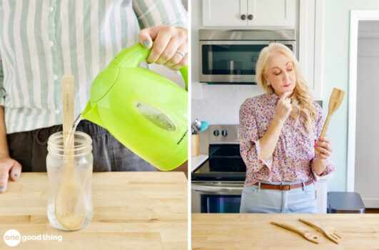 Pouring boiling water from a tea kettle onto a wooden spoon in a glass jar, woman looking quizzically at a wooden spoon.