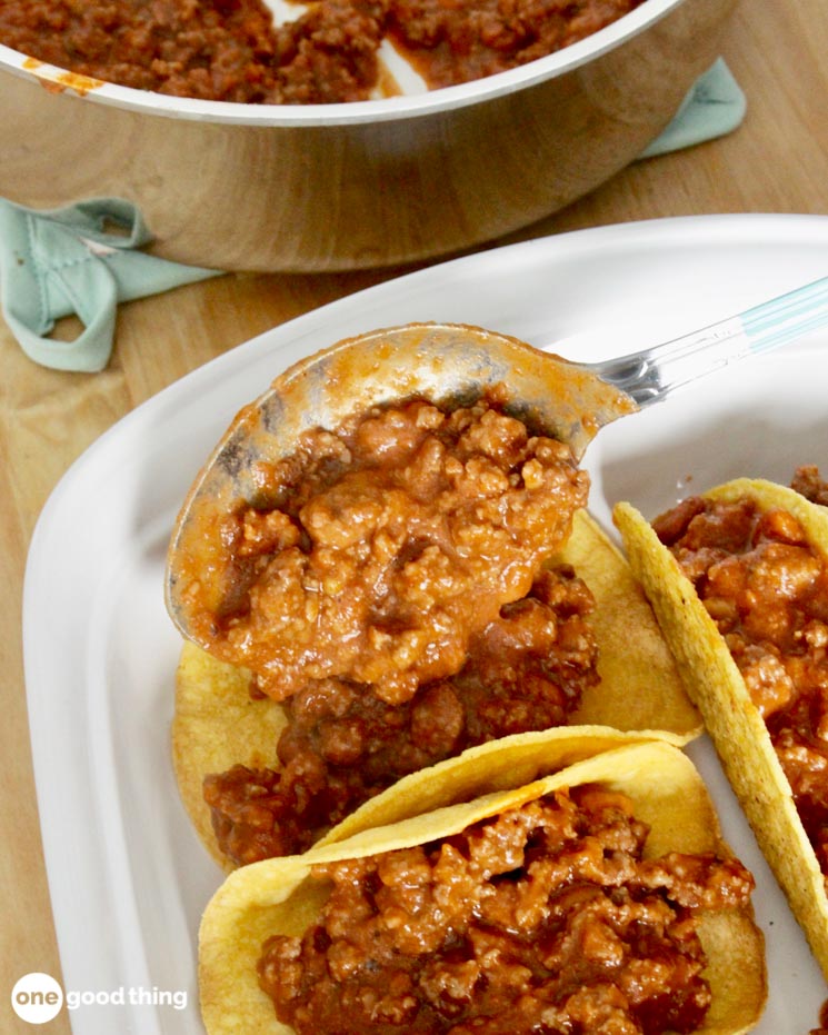 Spoon the taco filling into taco shells in a baking pan.