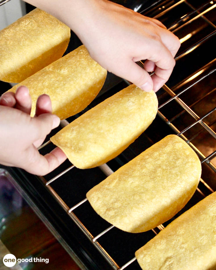 Drape the sprayed corn tortillas over two bars of your oven rack.