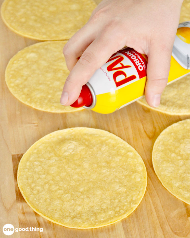 Spray the softened corn tortillas with a baking spray.