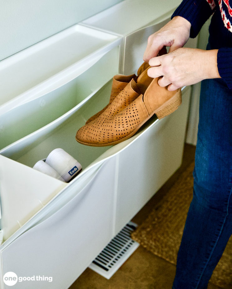 woman putting shoes into a bin