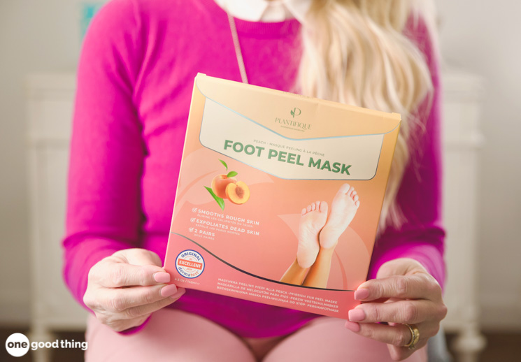 woman holding up the box for a peeling foot treatment