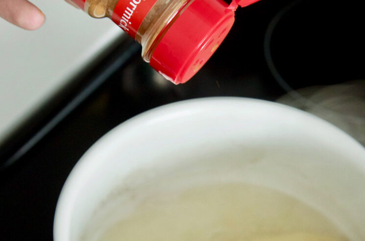 Make Banana Tea For Insomnia - sprinkling cinnamon into the pot with the water and banana
