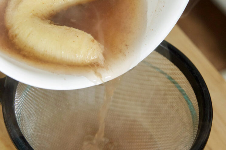 Make Banana Tea For Insomnia - straining the saucepan contents through a sieve