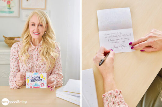 Woman with a colorful birthday card, woman writing inside the birthday card