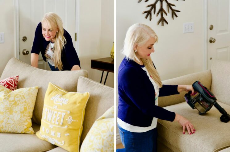 ruining your sofa - woman behind a sofa; woman vacuuming sofa cushion