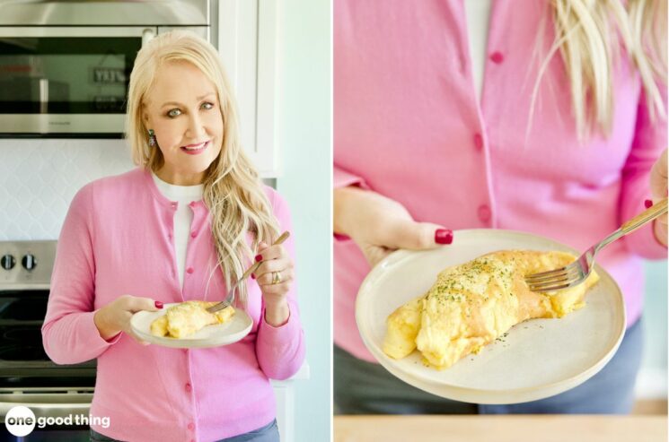 A woman with a fluffy copycat IHOP omelette on a plate.