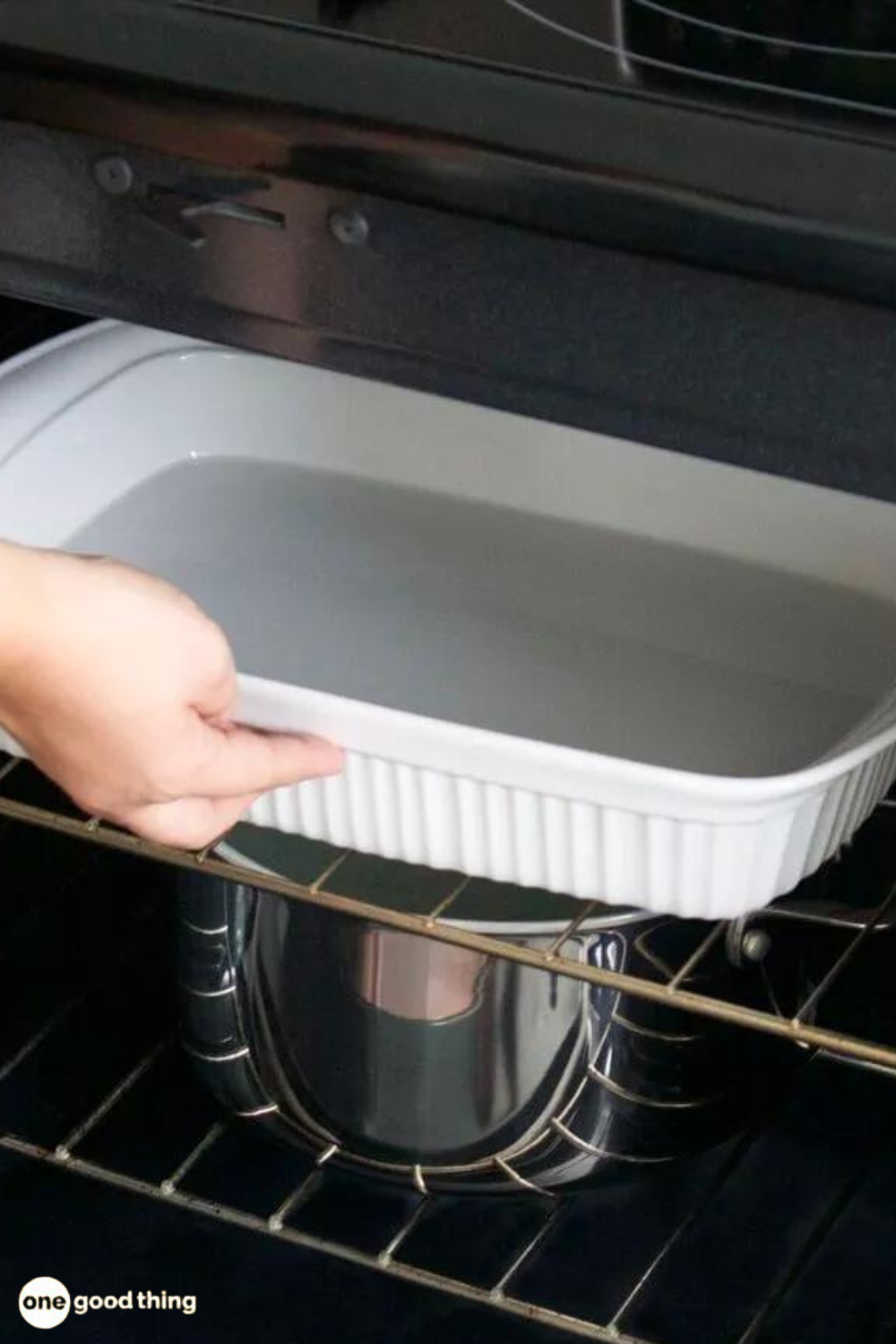 A person carefully removing a baking dish from the oven to ensure cleanliness and prevent any potential mess.