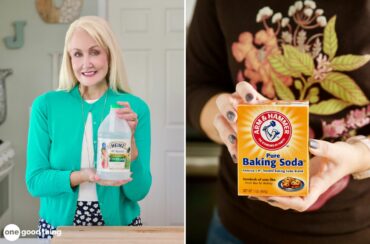 A woman holding a box of baking soda for cleaning purposes.