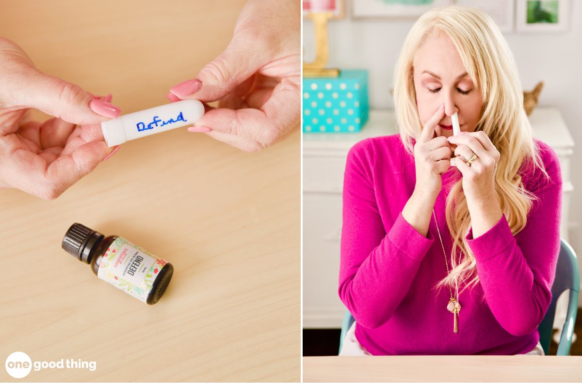 A woman is holding a bottle of essential oil and using it for cold relief.