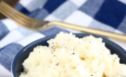Instant mashed potatoes in a bowl on a wooden cutting board.