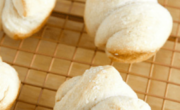 Freshly baked rolls, crafted from delicate pizza dough, cool gently on a wire rack.