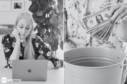A woman sits at a desk using a laptop and appears thoughtful; next to her, a hand places several dollar bills into a bucket, hinting at the unsettling realization that you've been scammed.