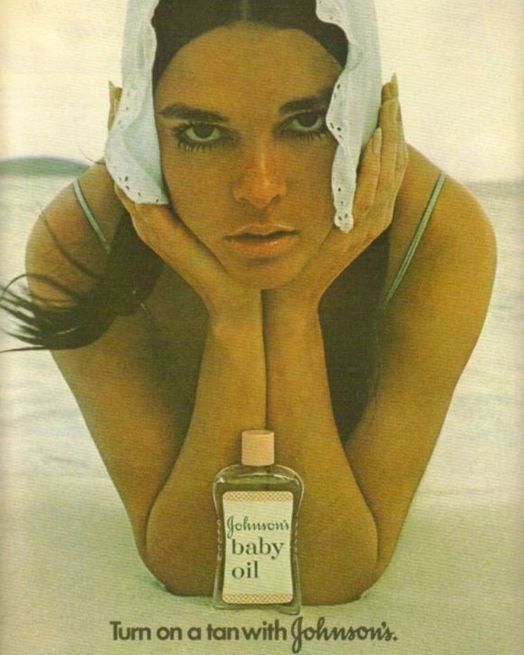skincare confessions_3 A woman with a white cloth on her head lies on her stomach at the beach, with a bottle of Johnson's baby oil in front; text reads,