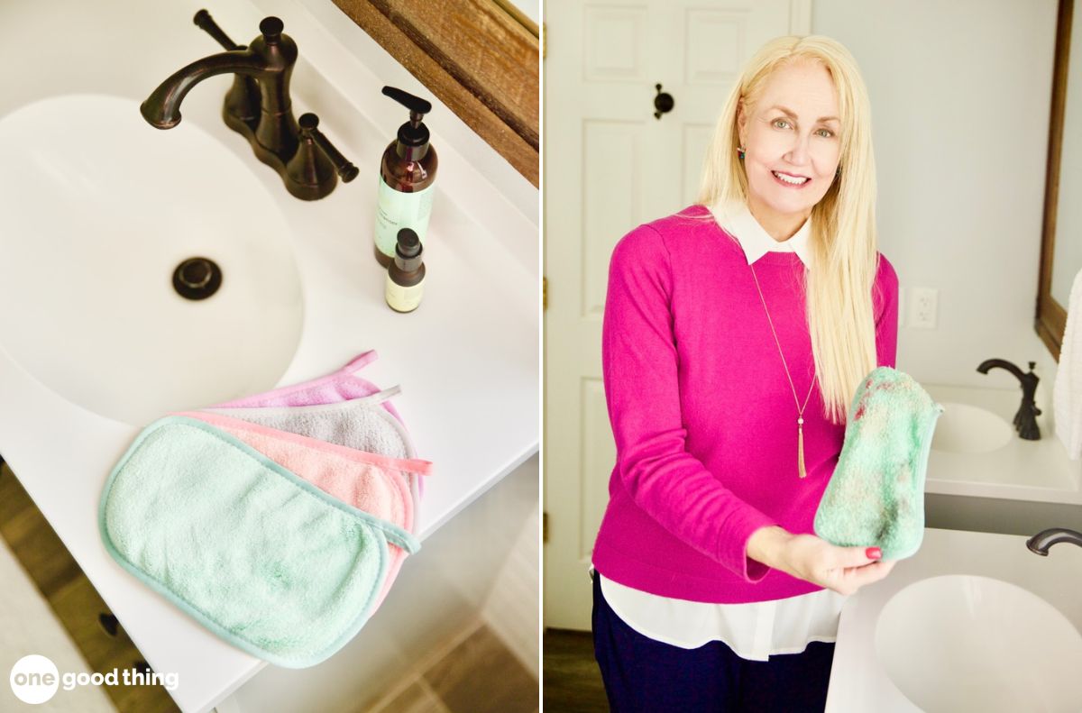 A bathroom sink with three microfiber cloths and hand soap on the left; a woman in a pink sweater holding a green microfiber cloth, perfect for oil cleansing, by the sink on the right.