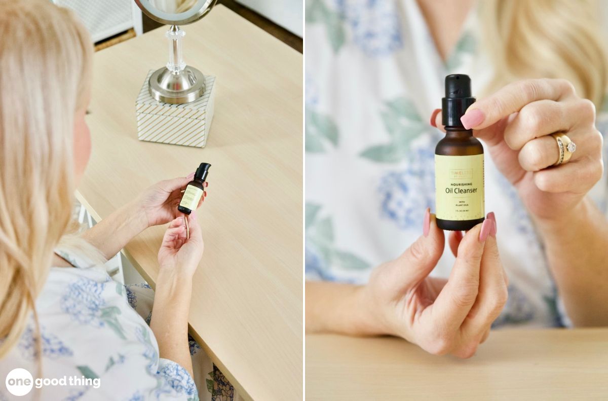 A woman sitting at a desk holds and examines a small bottle labeled 