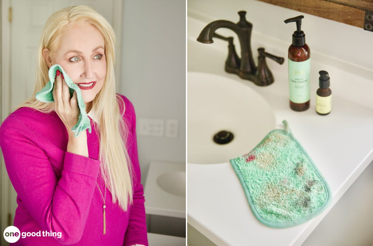 A woman practices oil cleansing, wiping her face with a green washcloth in a bathroom; next to it, the dirty washcloth rests by a sink with skincare bottles nearby.