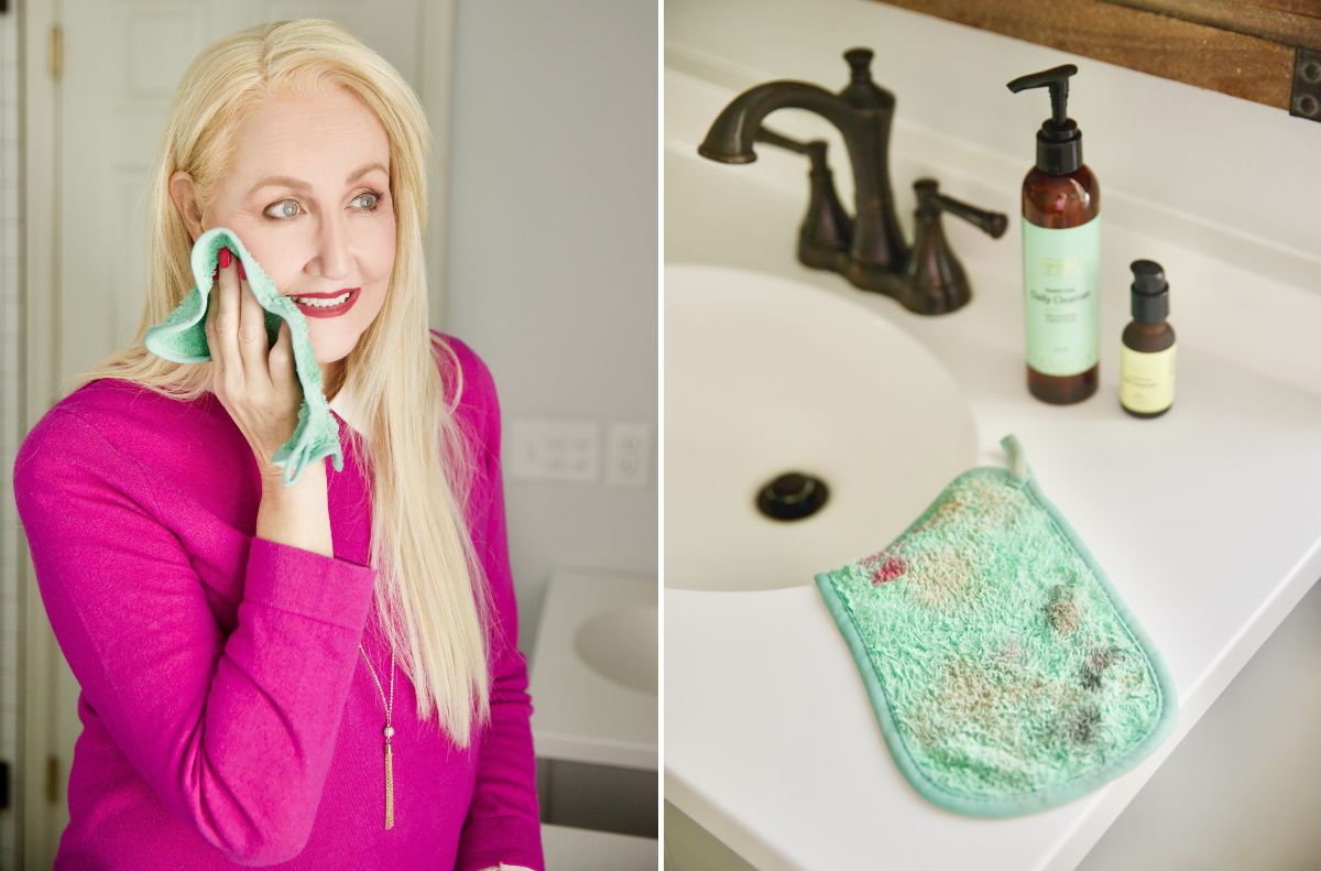 A woman in a magenta top wipes her face with a green cloth—beauty edition. Next to her, the now dirty cloth rests on a bathroom counter near a faucet and two bottles.