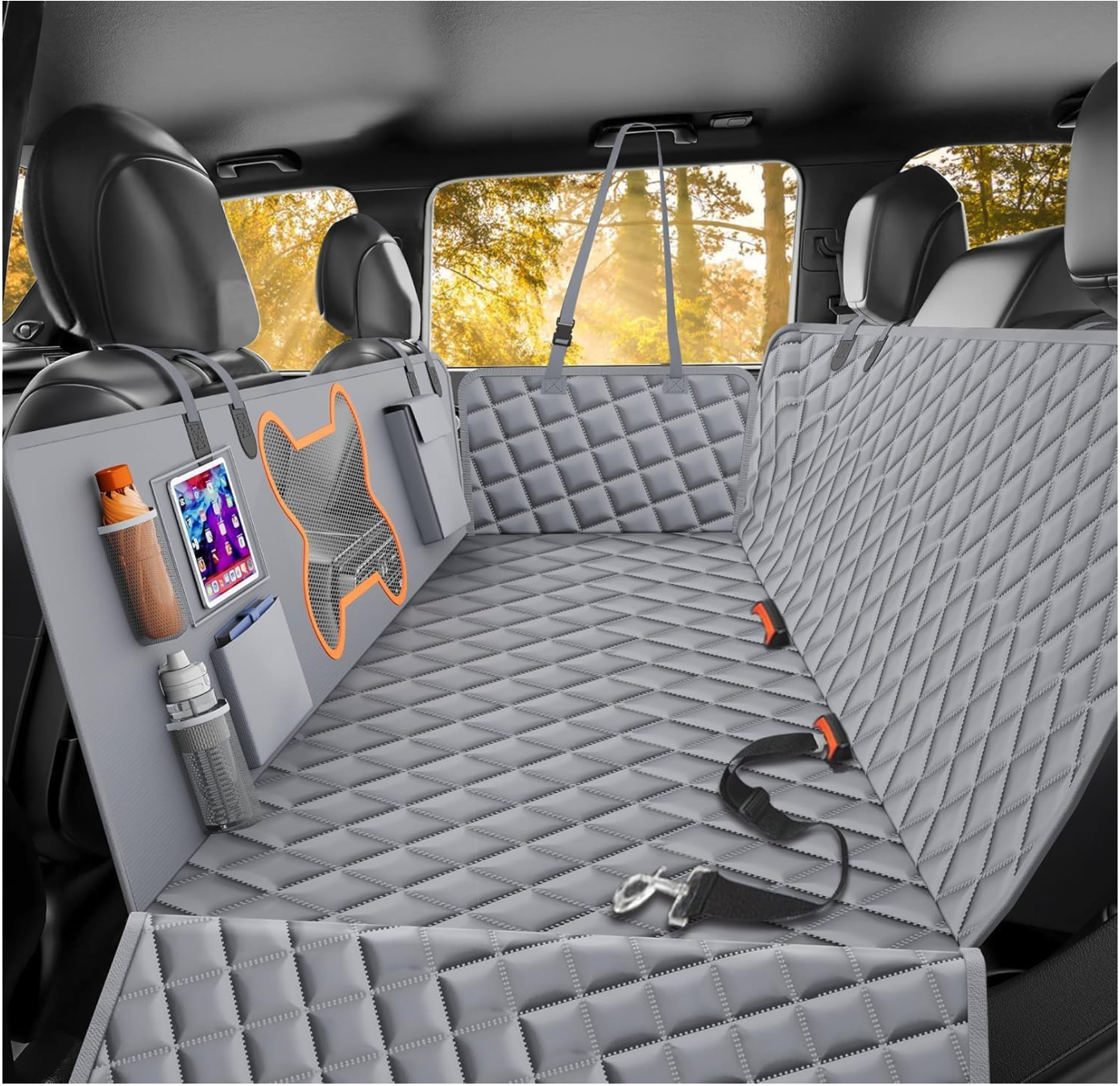 Gray quilted car seat cover with built-in dog seat belt, side pockets, water bottle, and tablet holder—an essential addition installed on the back seat of a vehicle for pet safety and organization. Ideal for those who appreciate car cleaning hacks, this cover helps keep your interior tidy while making road trips comfortable for both you and your furry companion.